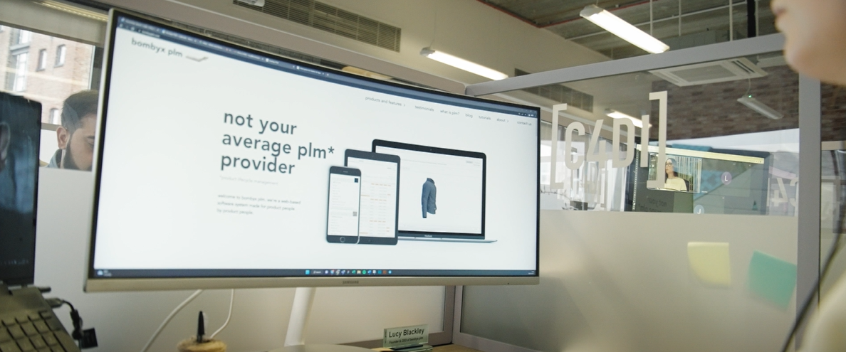 The image displays 2 employees of Bombyx PLM having a meeting.