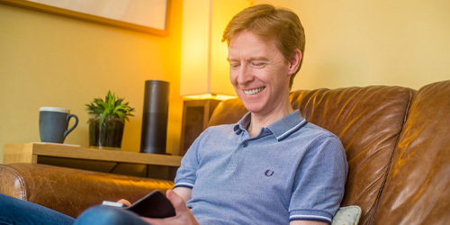Happy man using mobile phone
