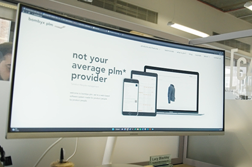 The image displays 2 employees of Bombyx PLM having a meeting.