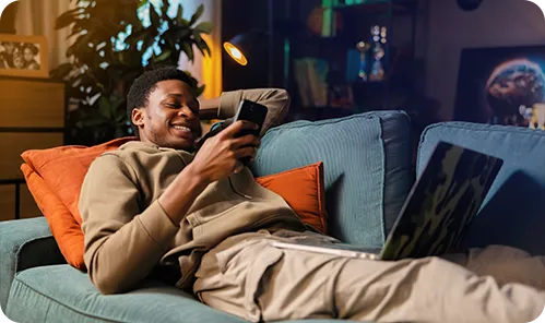 Image shows a man scrolling on his phone