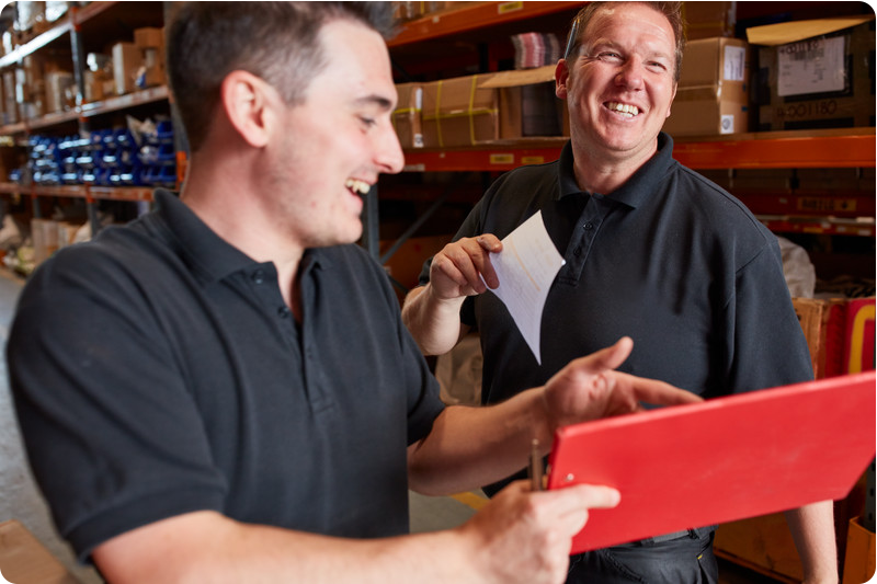 Two KCOM employees smiling working together