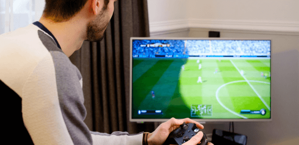 Man streaming football on TV