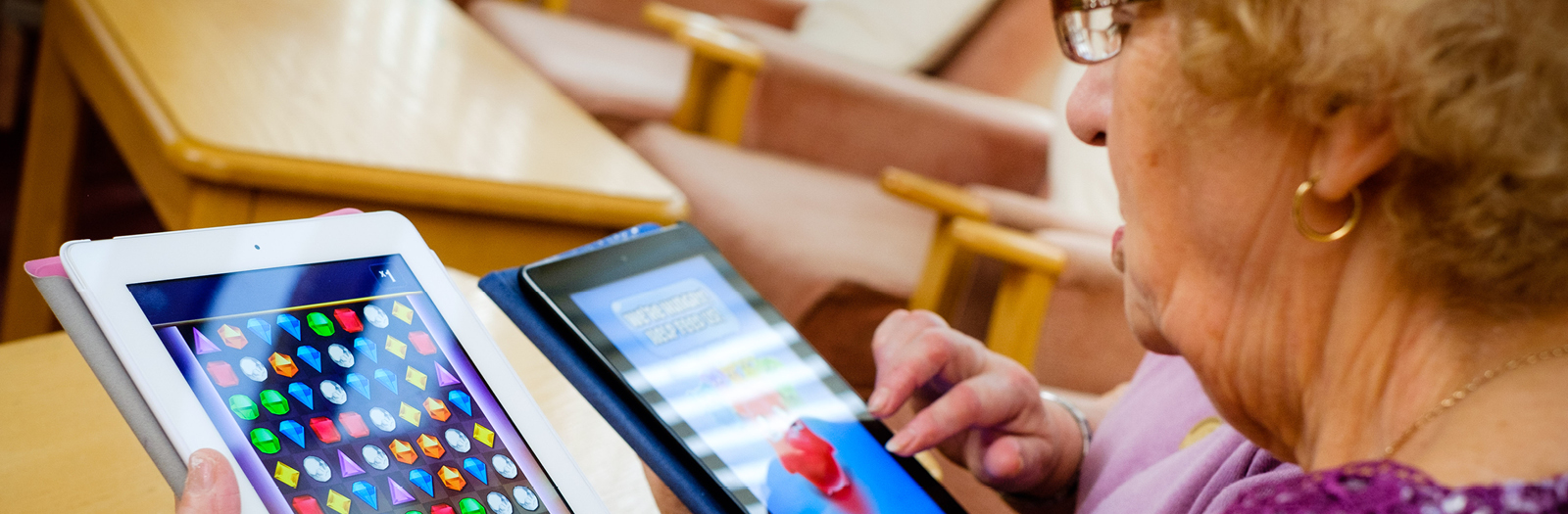 An elderly lady learning to use her ipad