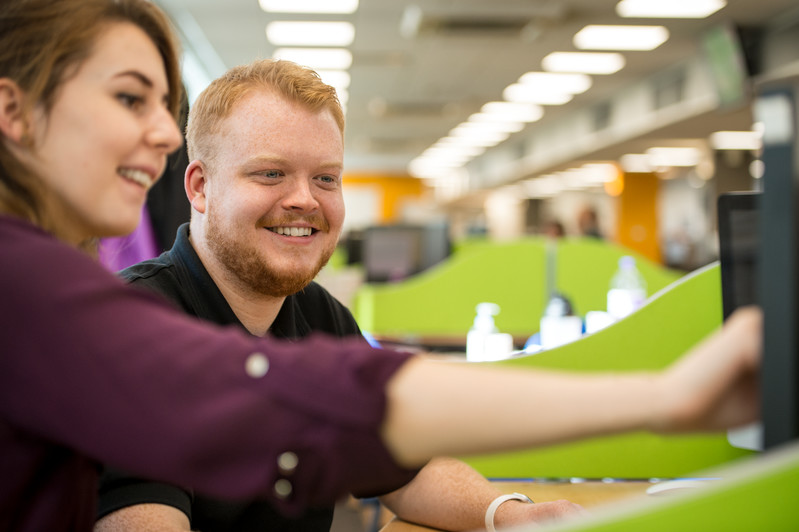 KCOM employees happily working at desk