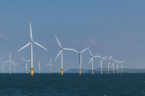 Image shows an wind farm on the ocean