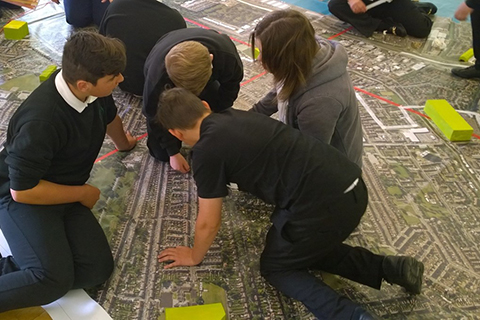 High school children completing the Internet Inventor activity on a huge map.