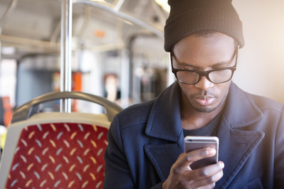 Man on bus using phone