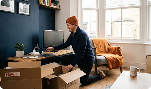 Man unpacking in new home