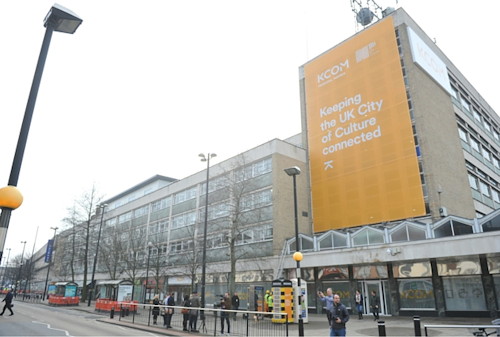 KCOM's Carr Lane office with large orange branded banner draped across front of building.