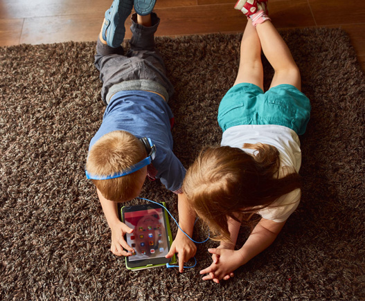 Two children playing on iPad