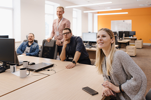 A group of colleagues actively participating in a discussion, reflecting collaboration, communication, and teamwork in a professional setting.