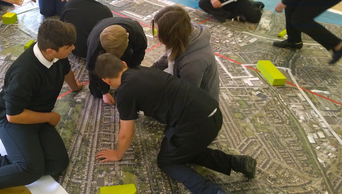 High school children completing the Internet Inventor activity on a huge map.