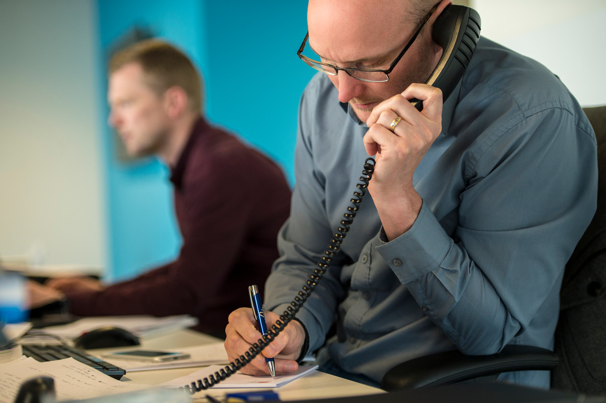 Men working at desk on the phone