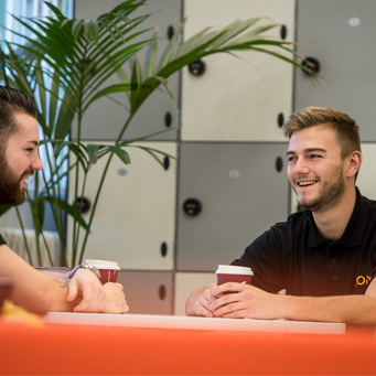 Two KCOM employees enjoying a coffee