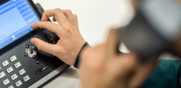 Person using business phone handset