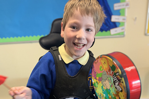 A youngster at Tweendykes School makes music with instruments bought with a KCOM grant